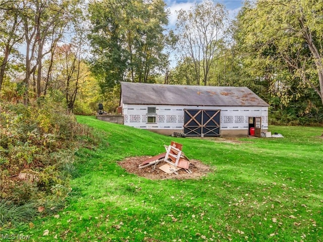 view of outbuilding featuring a yard