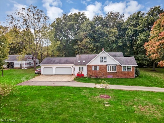 view of front facade with a garage and a front lawn