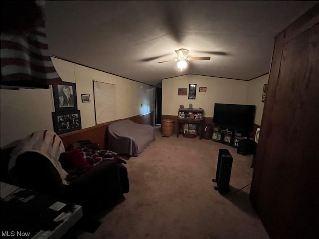carpeted living area featuring vaulted ceiling and a ceiling fan