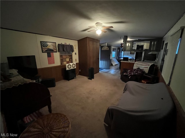 living room with carpet floors, ceiling fan, and lofted ceiling