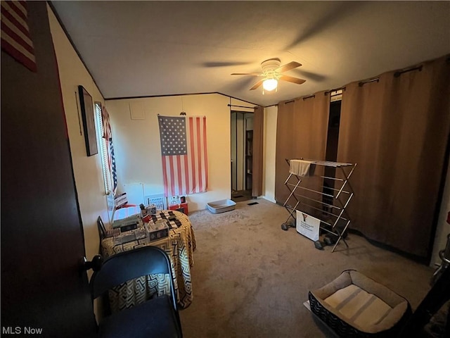 bedroom featuring lofted ceiling, carpet floors, and a ceiling fan