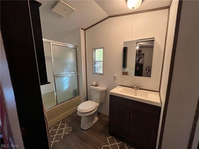 full bath with lofted ceiling, toilet, enclosed tub / shower combo, vanity, and wood finished floors