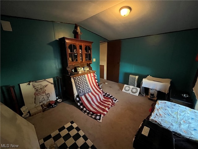 carpeted bedroom featuring radiator and lofted ceiling