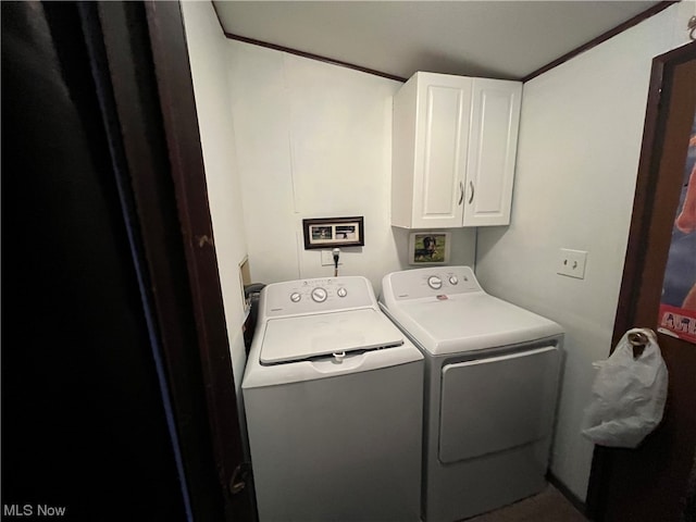 clothes washing area featuring cabinets, independent washer and dryer, and ornamental molding