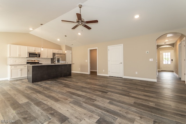 kitchen featuring appliances with stainless steel finishes, ceiling fan, a center island with sink, white cabinetry, and dark hardwood / wood-style floors