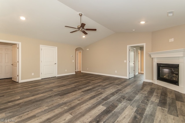 unfurnished living room featuring dark hardwood / wood-style floors, vaulted ceiling, and ceiling fan