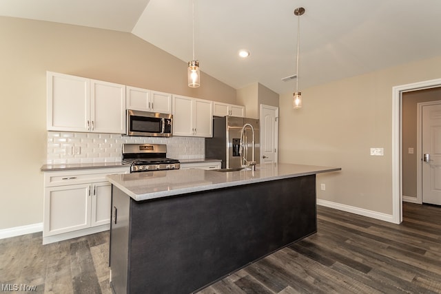 kitchen featuring lofted ceiling, hanging light fixtures, dark hardwood / wood-style floors, white cabinetry, and appliances with stainless steel finishes