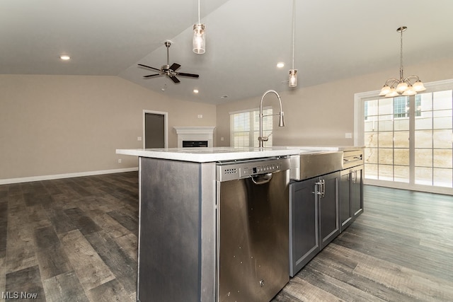 kitchen featuring decorative light fixtures, dark wood-type flooring, a center island with sink, dishwasher, and ceiling fan with notable chandelier