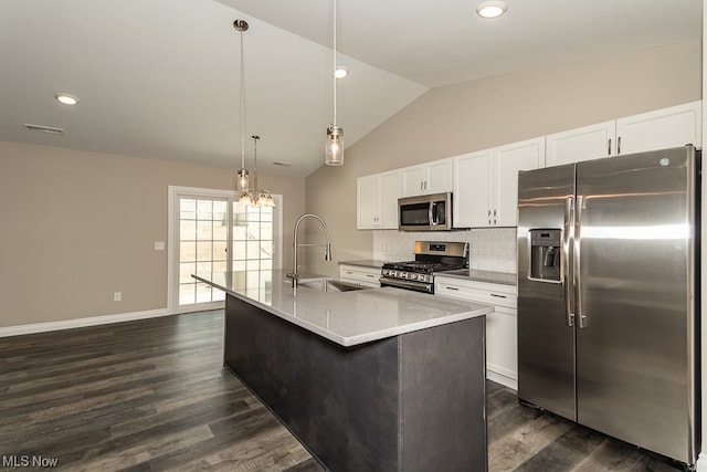 kitchen featuring appliances with stainless steel finishes, pendant lighting, sink, and dark hardwood / wood-style flooring