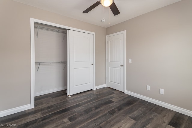 unfurnished bedroom with dark hardwood / wood-style flooring, a closet, and ceiling fan