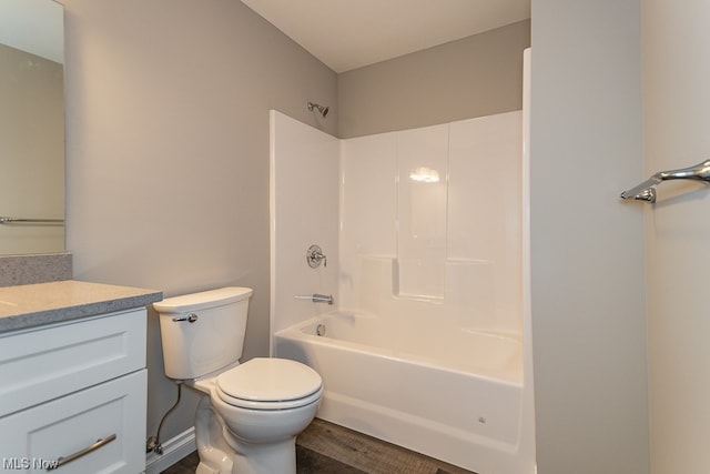 full bathroom with wood-type flooring, toilet, oversized vanity, and bathing tub / shower combination