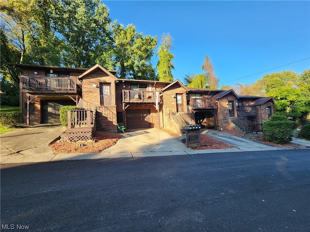 view of front of property featuring a balcony and a garage