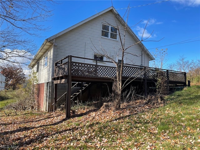 back of property featuring a wooden deck