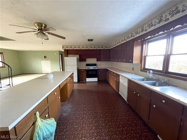 kitchen with sink, a textured ceiling, ceiling fan, and white appliances