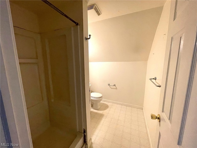 bathroom with toilet, tile patterned floors, and a shower