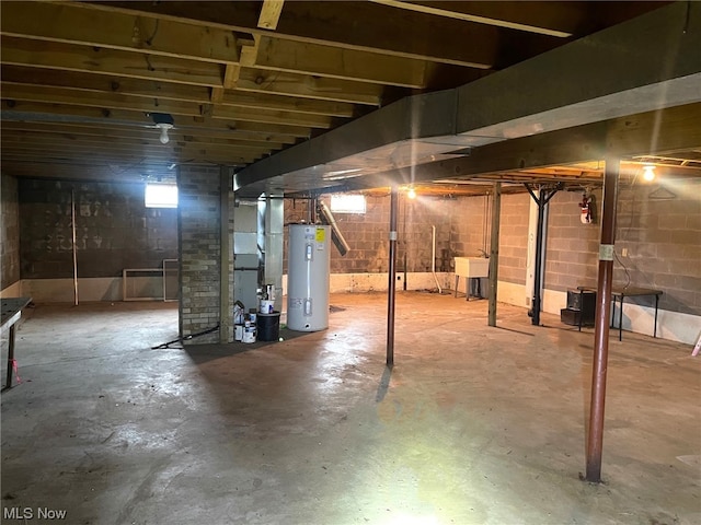 basement featuring sink and electric water heater