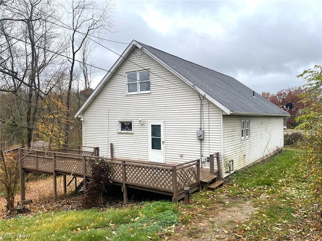 back of house with a deck