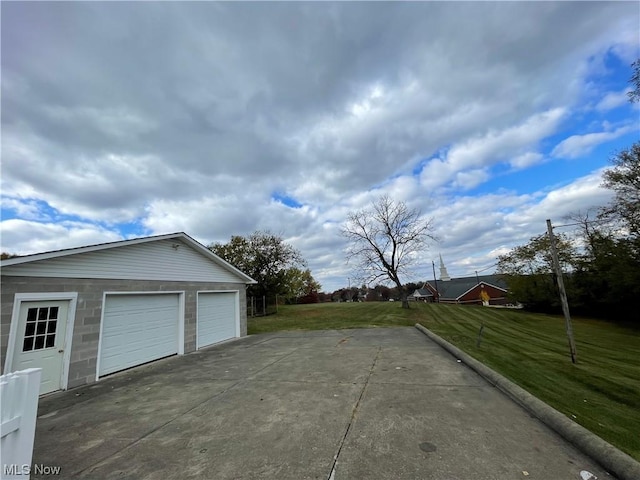 exterior space with a lawn, an outbuilding, and a garage