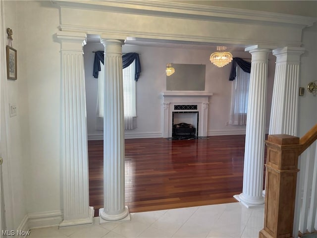 unfurnished living room with a notable chandelier and light tile patterned flooring