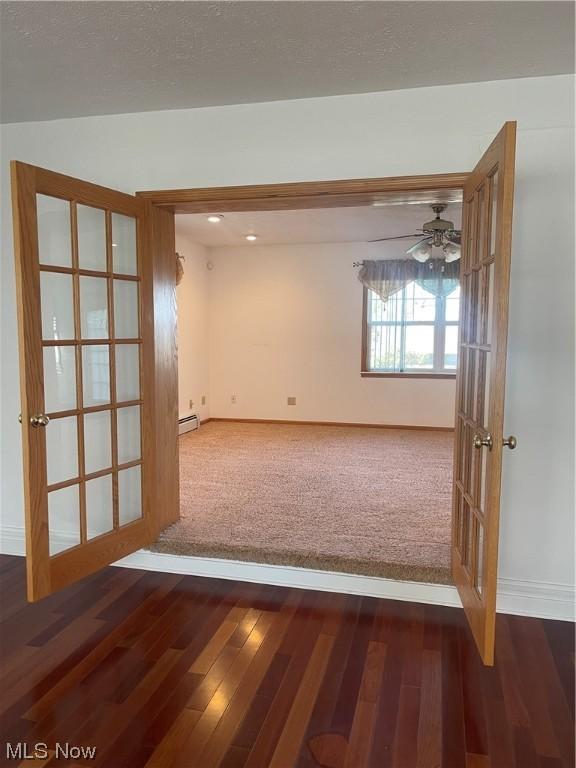 spare room with french doors, dark hardwood / wood-style flooring, and ceiling fan