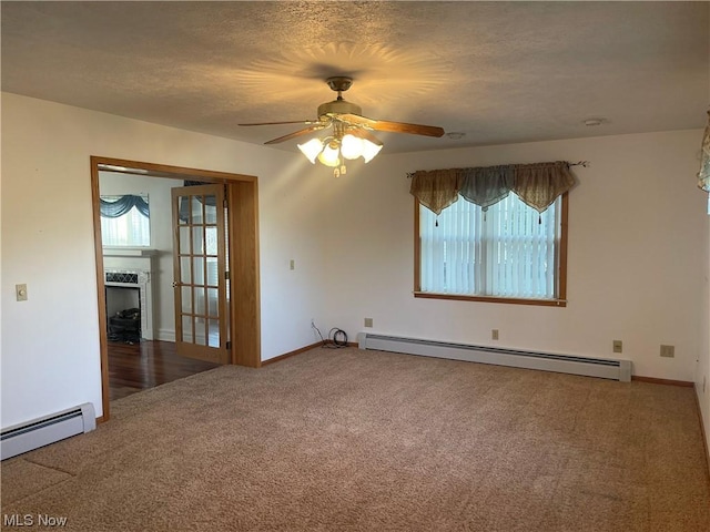 spare room with ceiling fan, a baseboard radiator, a textured ceiling, and dark colored carpet