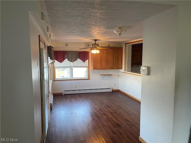 kitchen with a textured ceiling, dark hardwood / wood-style flooring, a baseboard radiator, and ceiling fan