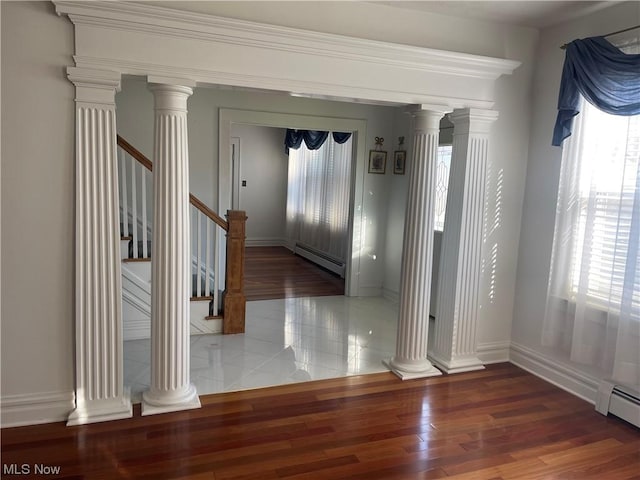 interior space with dark hardwood / wood-style floors and a baseboard heating unit