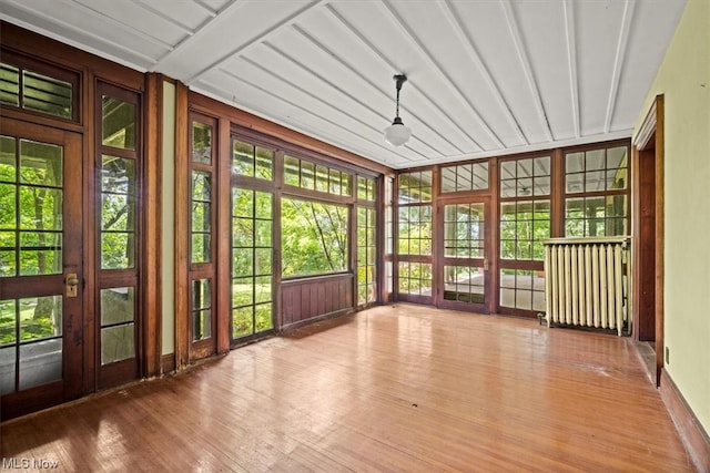 unfurnished sunroom with radiator heating unit