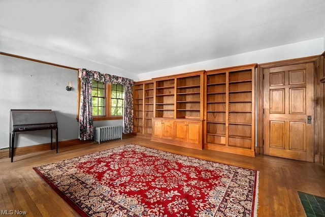 unfurnished room with wood-type flooring and radiator