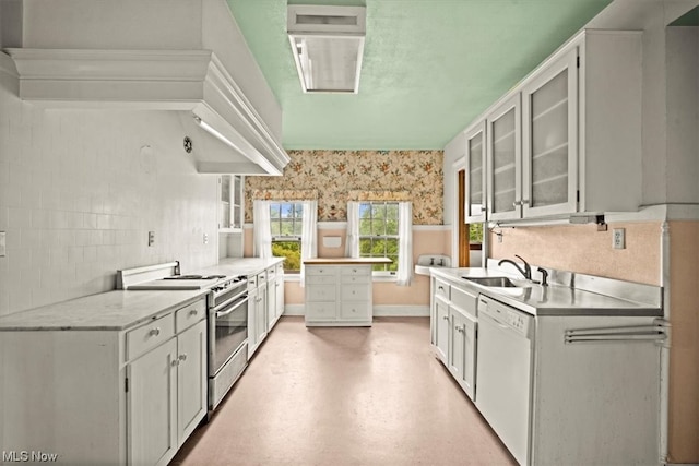 kitchen featuring white cabinets, range with gas cooktop, backsplash, sink, and dishwasher