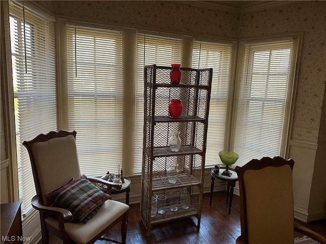 living area with dark hardwood / wood-style floors, plenty of natural light, and crown molding