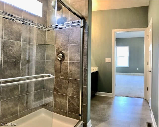 bathroom with vanity and a shower with shower door