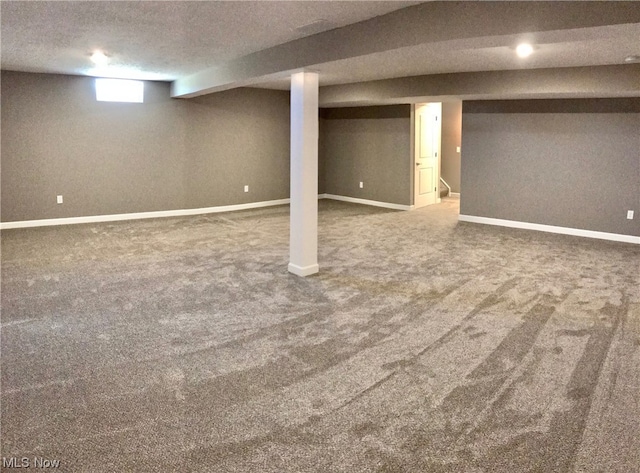 below grade area featuring baseboards and carpet flooring