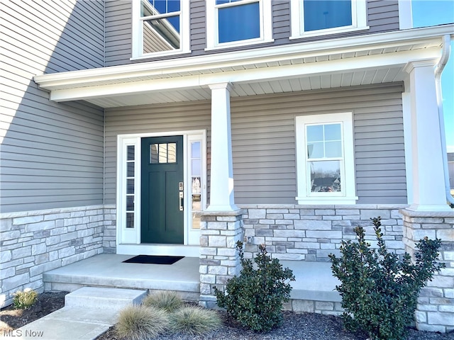 entrance to property featuring covered porch