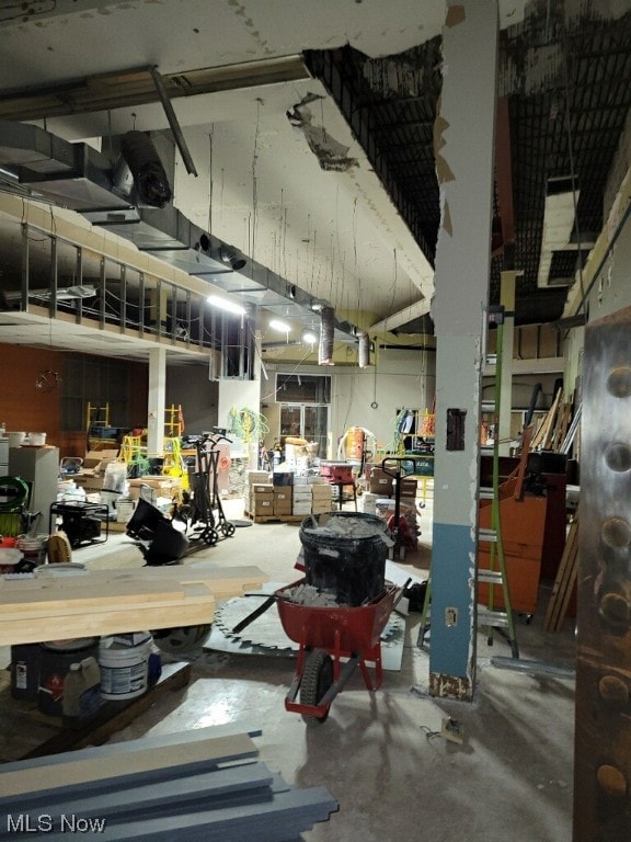 interior space featuring concrete flooring and a workshop area