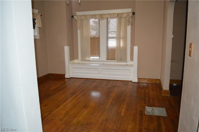 empty room with dark wood-type flooring