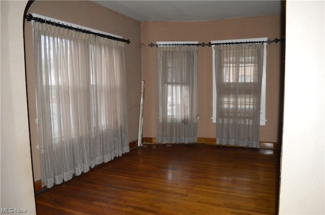 unfurnished room with dark hardwood / wood-style floors