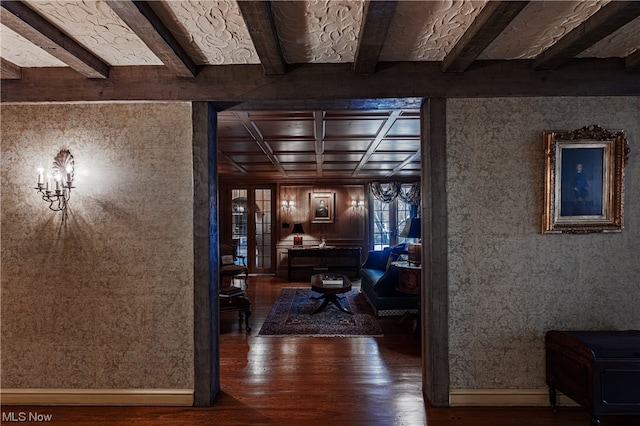 hallway with hardwood / wood-style flooring, beamed ceiling, and french doors