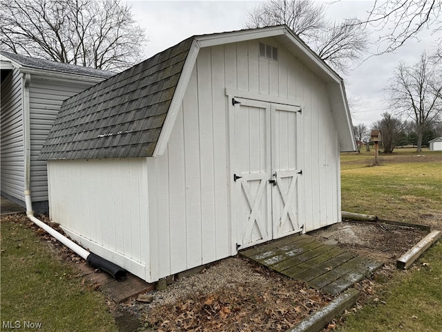 view of outdoor structure featuring a lawn