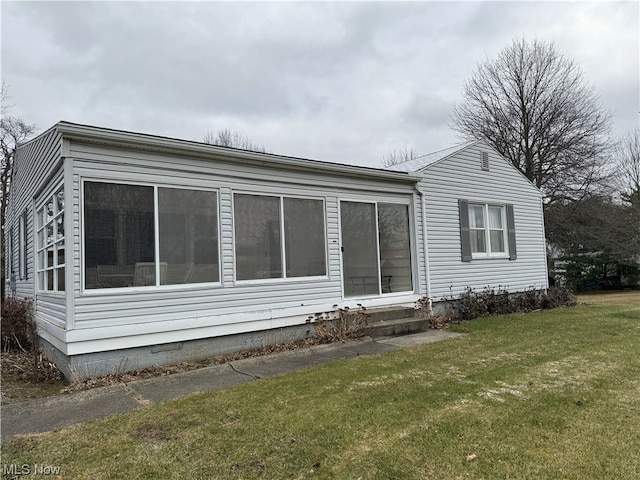 view of property exterior with a lawn