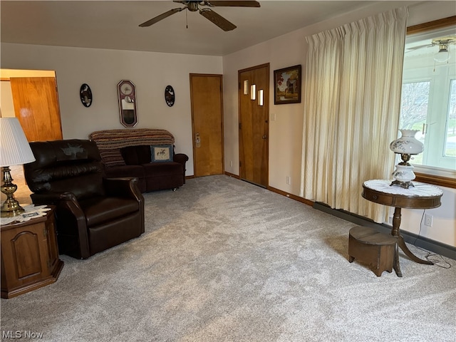 living room featuring ceiling fan and light colored carpet