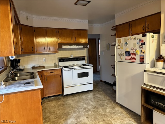 kitchen with exhaust hood, white appliances, tasteful backsplash, and sink