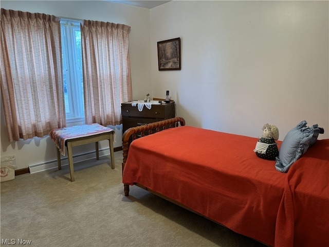 bedroom featuring carpet floors and a baseboard heating unit