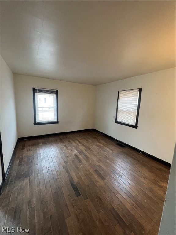 spare room featuring dark hardwood / wood-style floors