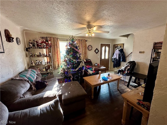 living room featuring a textured ceiling, hardwood / wood-style floors, and ceiling fan