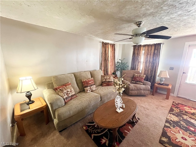 living room featuring ceiling fan, a textured ceiling, and carpet floors