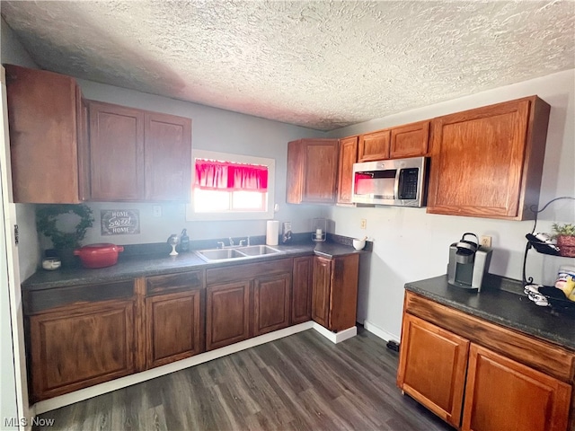 kitchen featuring dark hardwood / wood-style floors, a textured ceiling, and sink