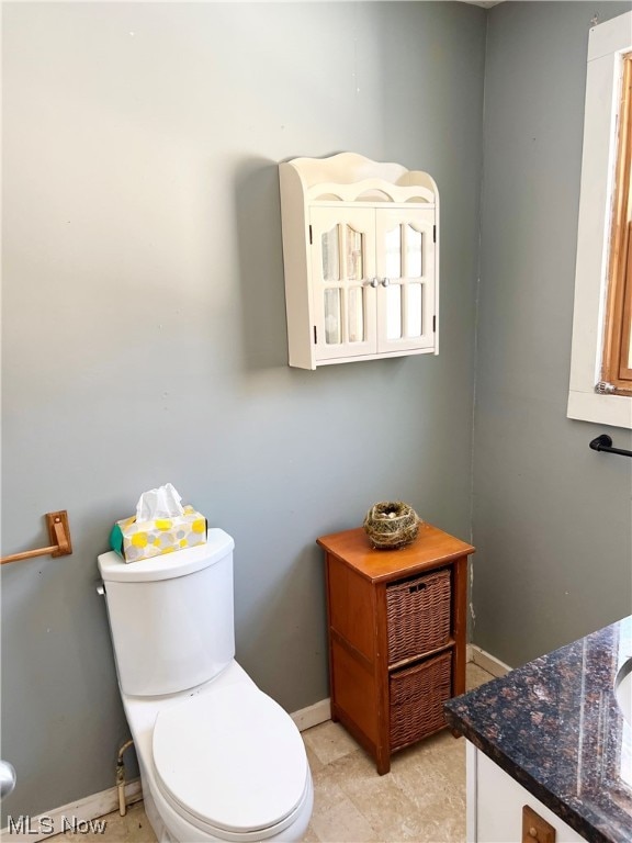 bathroom featuring vanity, toilet, and tile patterned flooring