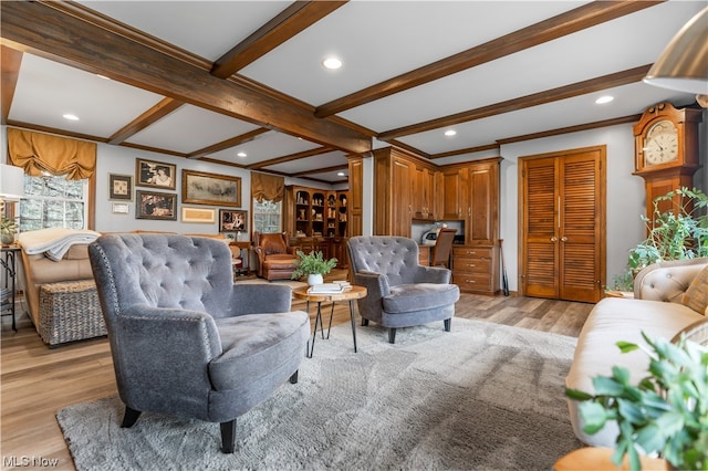 living room with beamed ceiling, ornate columns, and light hardwood / wood-style flooring