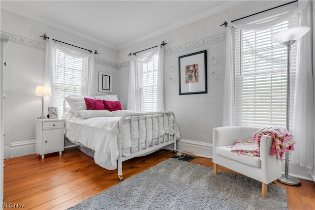 bedroom with wood-type flooring and crown molding